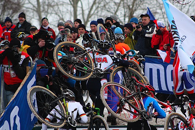 Going Up A crowded pack of 'cross racers carry their bikes up a steep grade