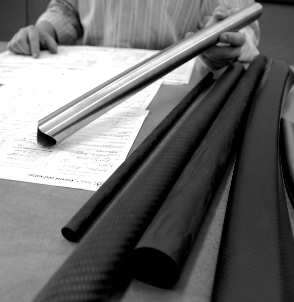 Various carbon and titanium tubes at a desk