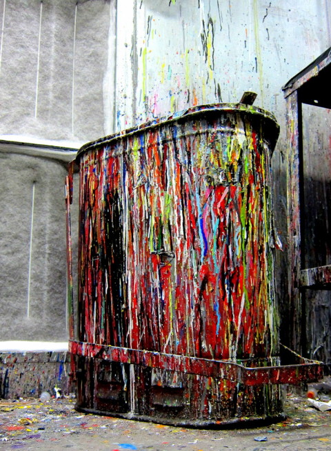 Bucket completely covred in multicolored paint drips