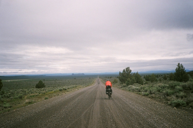 Cyclists riding an endless dirt road