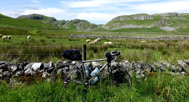 bike leaning on a stone fence