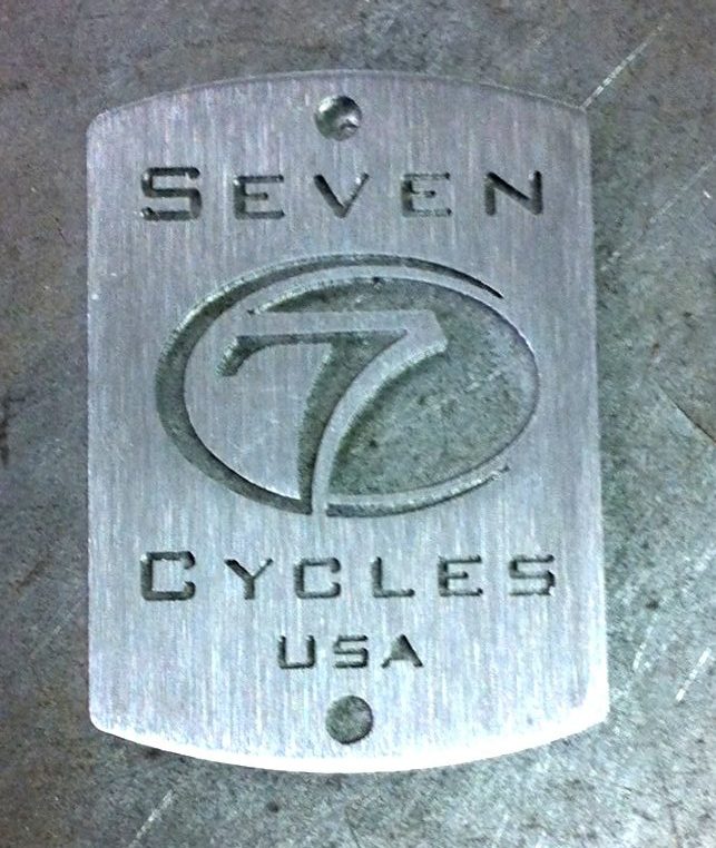 Seven head badge