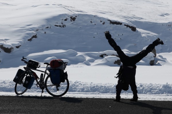 Doing a cartwheel next to a loaded touring bike in the snow