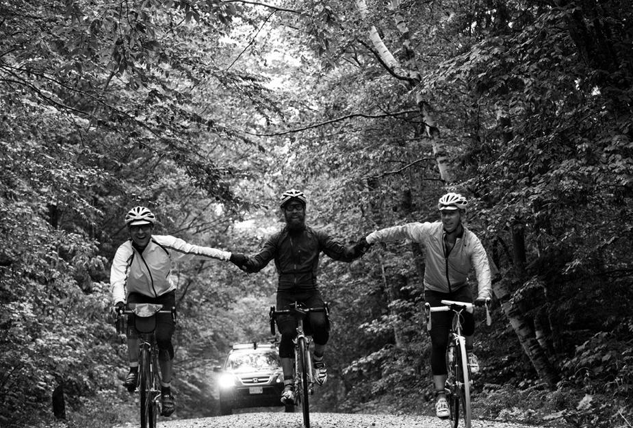three rides smiling and holding hands