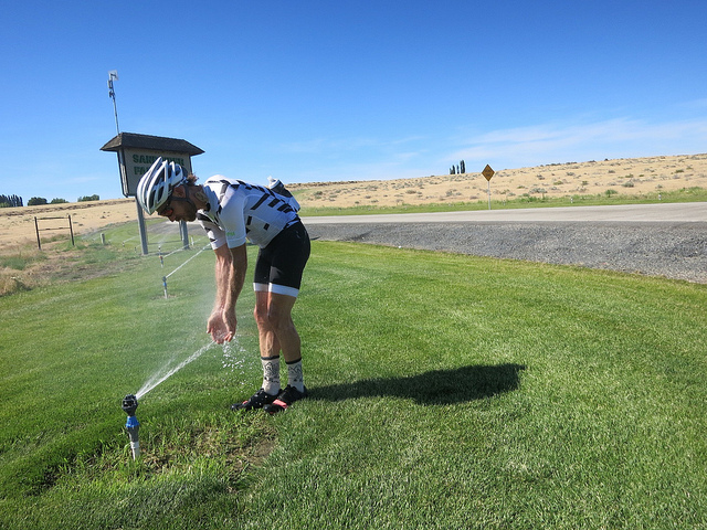 David takes advantage of a sprinkler to cool off