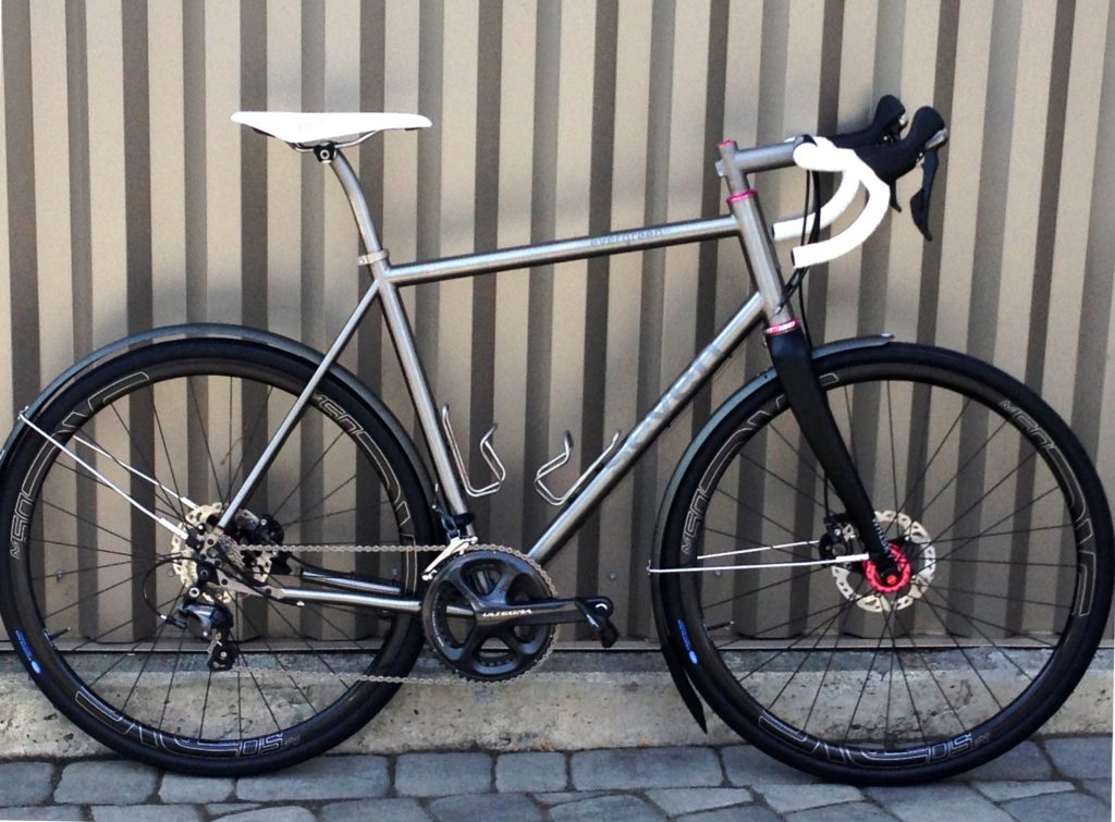An immaculate Seven Evergreen SL leans against an interesting steel wall
