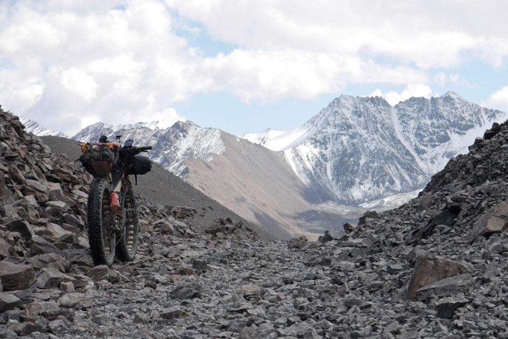 A Seven Treeline SL freestands before a rugged rocky path leadning off to distant imposing mountains