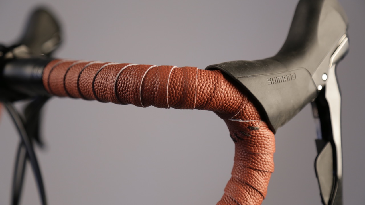 A closeup of grippy bar tape of an orange-brown color