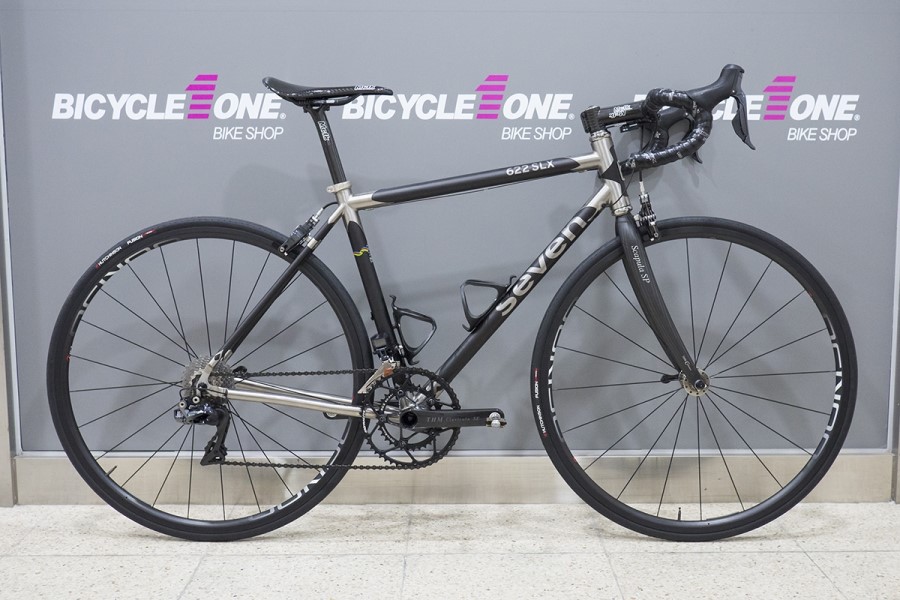 A perfect Seven 622 SLX leans against a wall with Bicycle One Bike Shop graphics