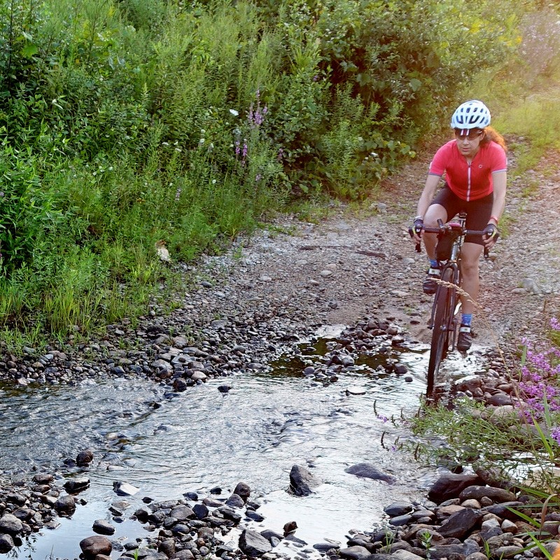 cyclist crossing a washout on a rough dirt road