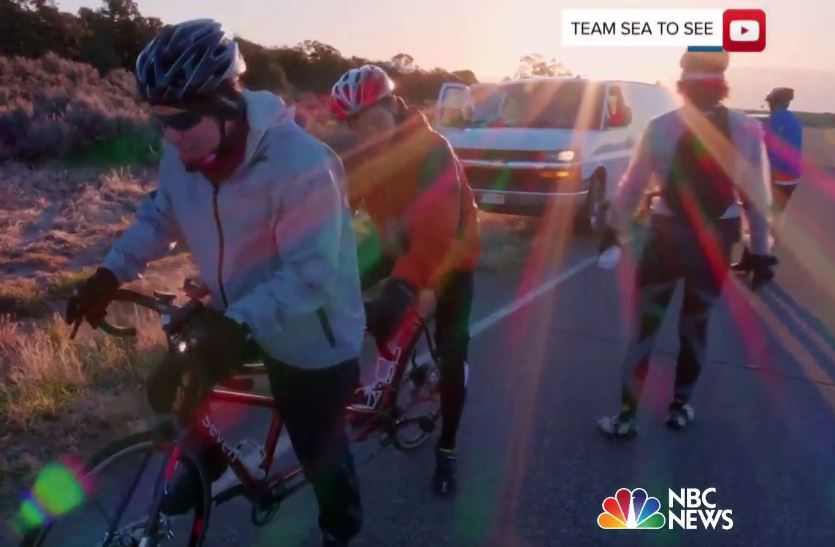 Dramatic image of a backlit sunrise shines on two hard-working tandem riders
