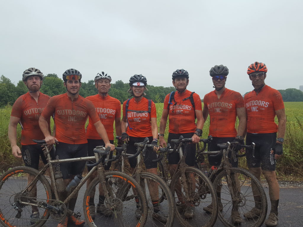 Team Outdoors Inc. posing with their muddy Mudhoneys
