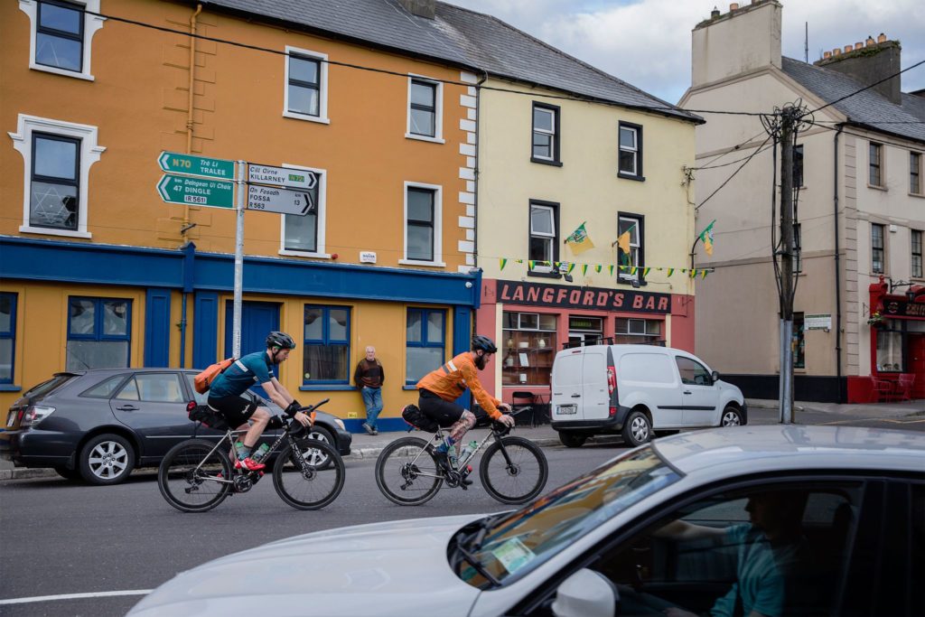 Brad and Matt ride through an Irish town