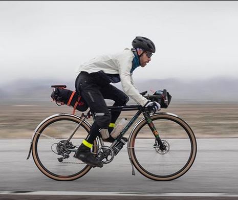 David Wilcox speesd along a flat foggy rad in his Randonne bike