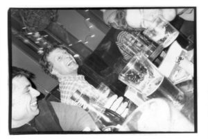 snapshot of folks laughing at a bar